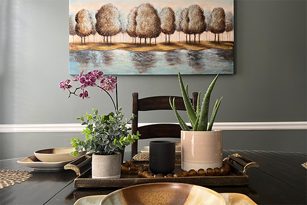 tablescape with painting of trees on wall